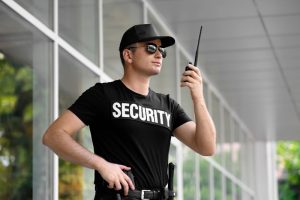 Male security guard with portable radio outdoors